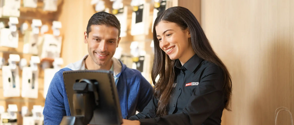 A customers smiling and engaging with a retail associate